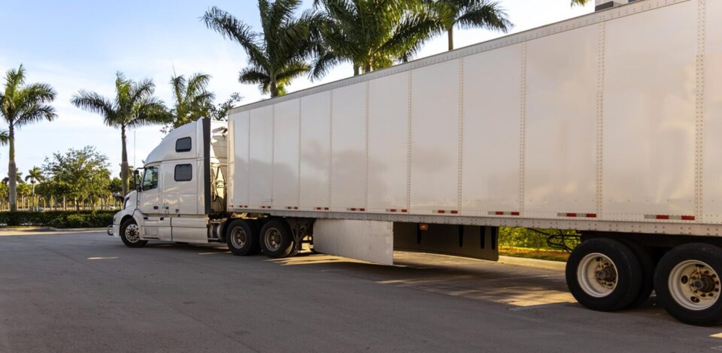 https://kfctrucking.ca/wp-content/uploads/2024/07/freepicdownloader.com-white-semi-truck-with-white-trailer-parked-side-road-large-1410x690.jpg